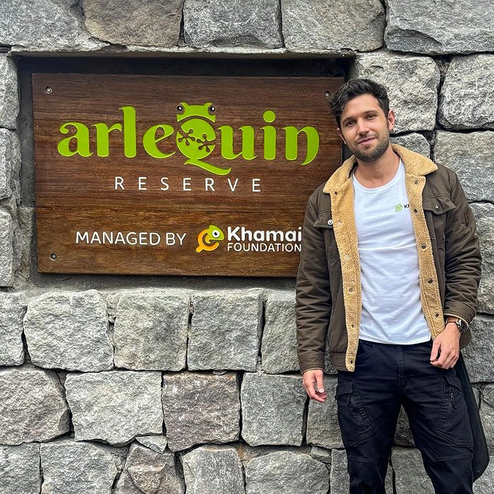 Alejandro Arteaga standing next to the entrance of the Arlequín Reserve