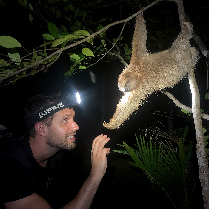 Alejandro Arteaga approaching a sleeping sloth in Bocas del Toro, Panama