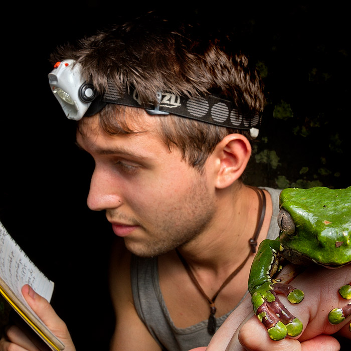 Alejandro Arteaga holding a frog in Tambopata, Peru