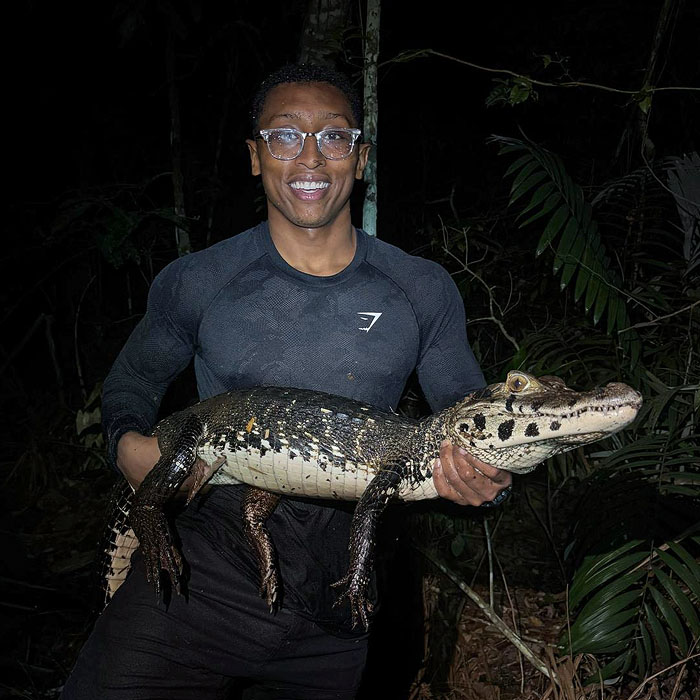 Image showing Khamai’s Ambassador Christian Cave holding a Black Caiman